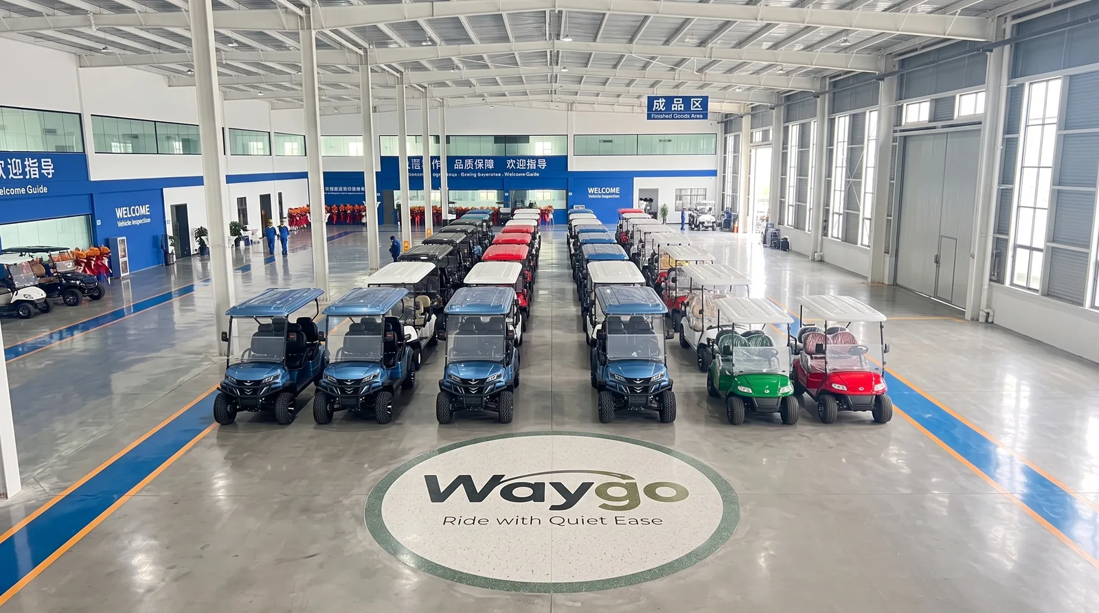 Electric golf carts arranged inside the Waygo factory facility