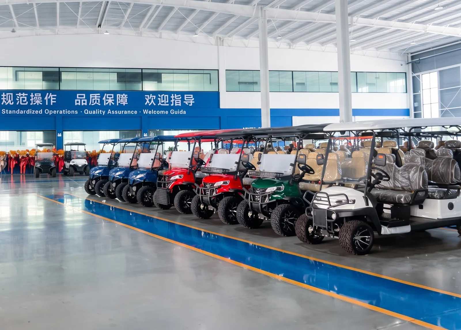 Electric golf carts lined up in the Waygo factory
