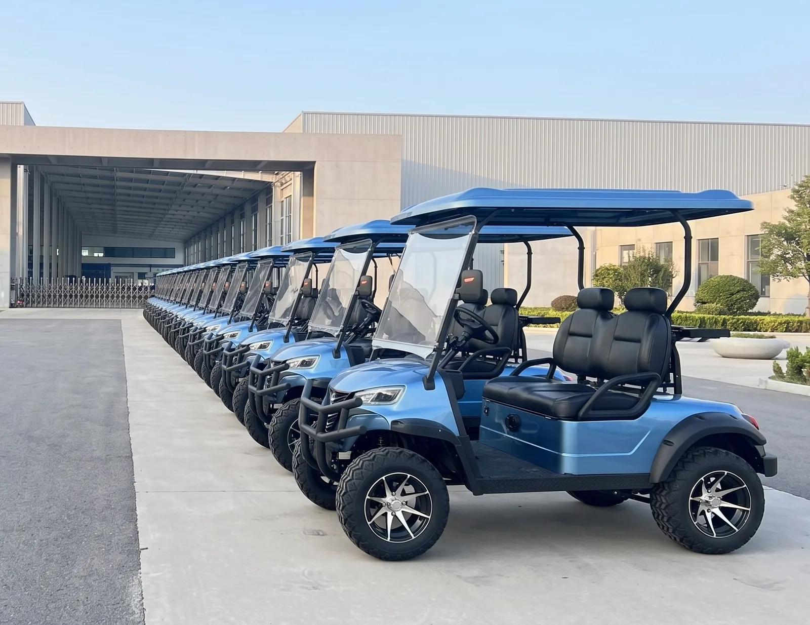 Electric golf carts lined up outside the Waygo factory