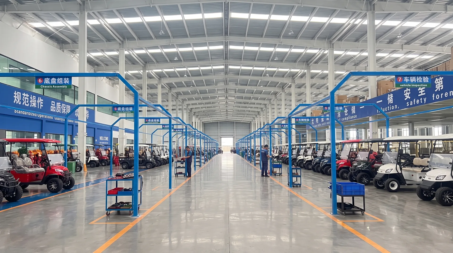 Electric golf carts arranged along a Waygo factory workshop aisle