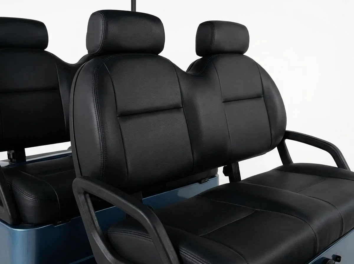 Black leather seats in a four-seat electric golf cart