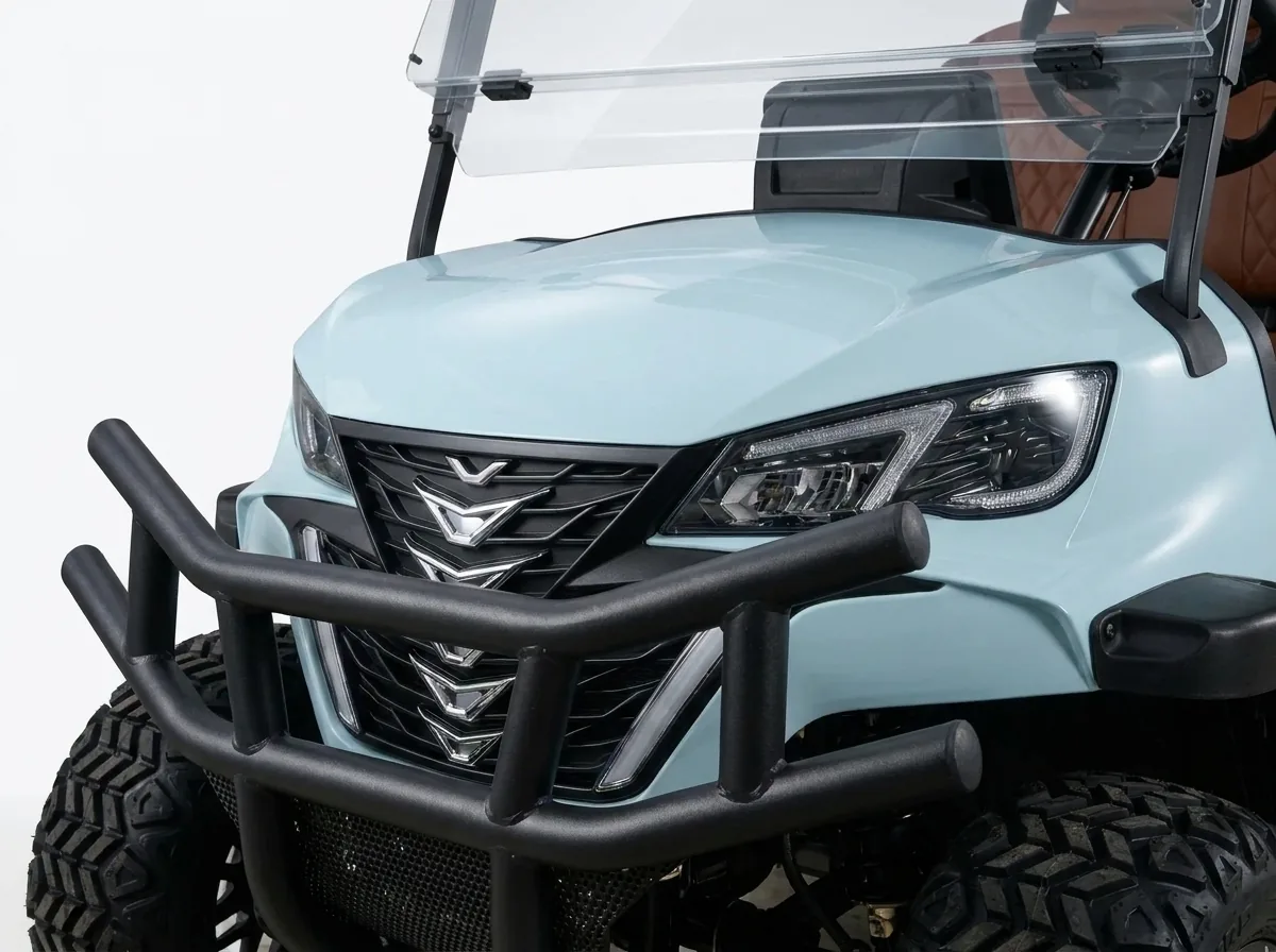 Headlight and front bumper detail of a six-seat electric golf cart